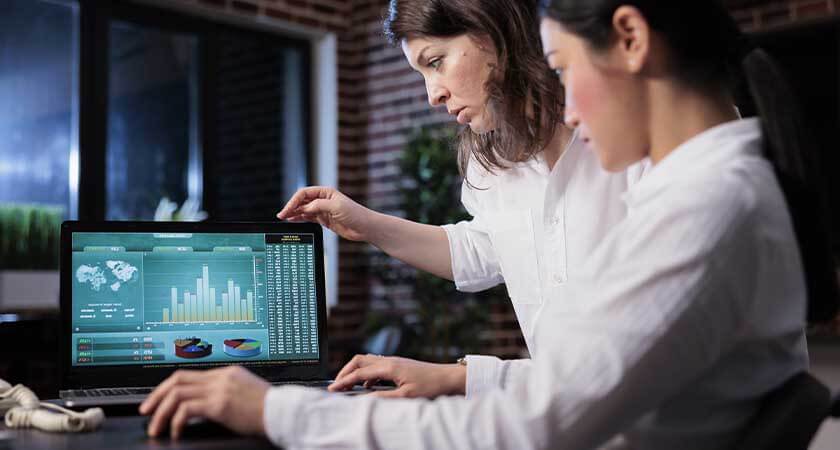 Two girls are studying the search traffic graph.